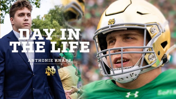 Notre Dame player in a green jersey celebrating on the field at Notre Dame Stadium during the Irish Wear Green Day game against Stanford